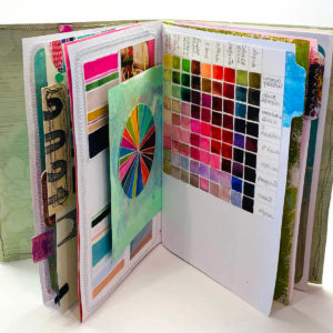 Design Extravaganza book, with the book open and colorful images on the pages - By Marsha Shaw